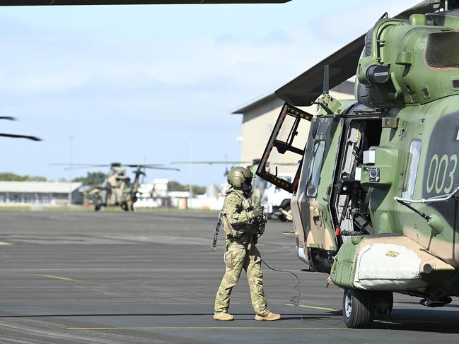 An Australian helicopter crewman prepares to board an MRH 90 at the Townsville airport as part of exercise Talisman Sabre 23. Picture: Getty