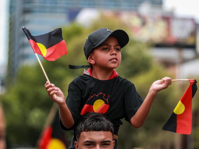 SYDNEY, AUSTRALIA - JANUARY 26: Demonstrators march towards Victoria Park during an Invasion Day protest on January 26, 2024 in Sydney, Australia. Australia Day, formerly known as Foundation Day, is the official national day of Australia and is celebrated annually on January 26 to commemorate the arrival of the First Fleet to Sydney in 1788. Many indigenous Australians refer to the day as Invasion Day and there is a growing movement to change the date to one which can be celebrated by all Australians. In 2024, supermarket Chains Woolworths and Aldi announced that they would stop stocking themed merchandise for the day, drawing a political backlash from opposition leader Peter Dutton. (Photo by Roni Bintang/Getty Images)