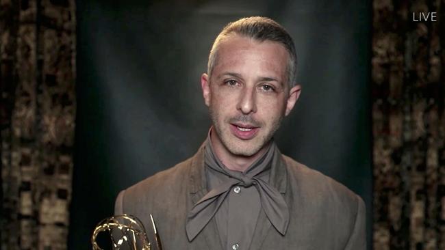 Succession star Jeremy Strong clutching his Emmy (and that neckline). Picture: AFP