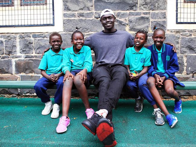 2/3/18 Actor / basketball player Wally Elnour with kids (L-R) Junior, Alady, Anei and Siena during a lunch break at Sacred Heart Primary school in Fitzroy. The school services a largely African refugee community from the nearby housing commission flats and has just hired Wally Elnour and Bakhita Dao to work at the school as engagement officers. Aaron Francis/The Australian