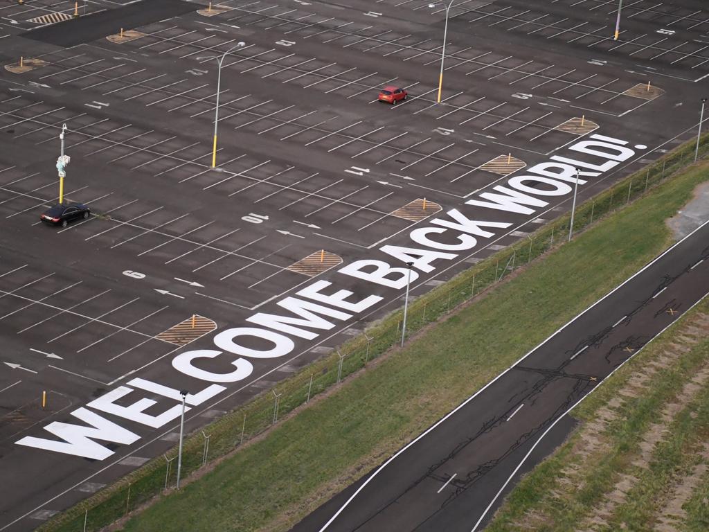 A 75-metre "Welcome Back World!" sign is painted adjacent to the runways at Sydney Airport. Picture: James D. Morgan/Getty Images