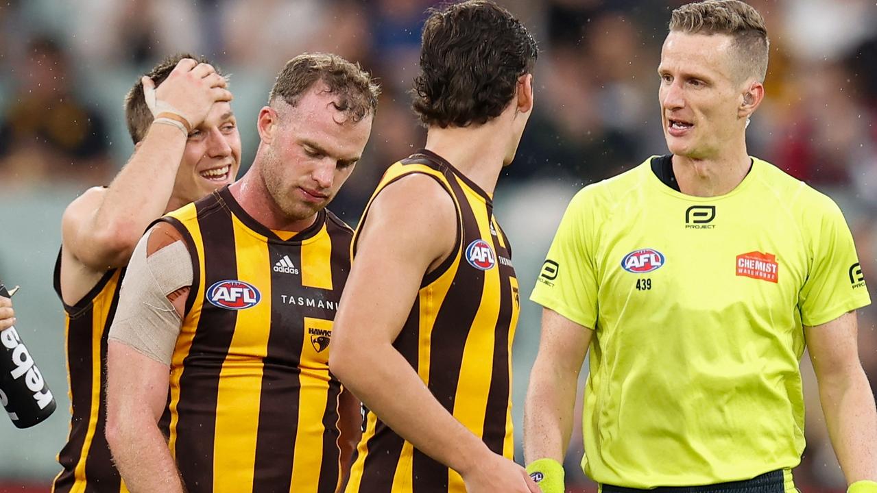 MELBOURNE, AUSTRALIA - APRIL 18: Tom Mitchell of the Hawks speaks with AFL Field Umpire, Hayden Gavine after a 50 metre penalty was awarded to Geelong during the 2022 AFL Round 05 match between the Hawthorn Hawks and the Geelong Cats at the Melbourne Cricket Ground on April 18, 2022 In Melbourne, Australia. (Photo by Michael Willson/AFL Photos via Getty Images)