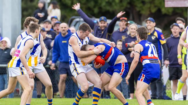 Somerville captain Luke Burton collars a Mornington opponent on Saturday. Picture: Al Dillon