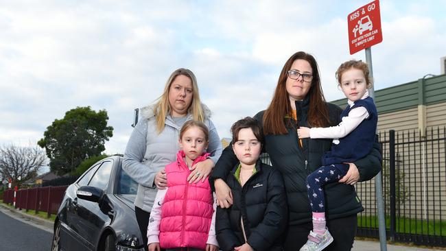 Keren Barak with Lia, 7 and Eva, 8 and Elizabeth Michelini and Rosie, 4. The mums say they have been using the Kiss and Go zones for years and can’t understand the sudden fines. Picture: Josie Hayden