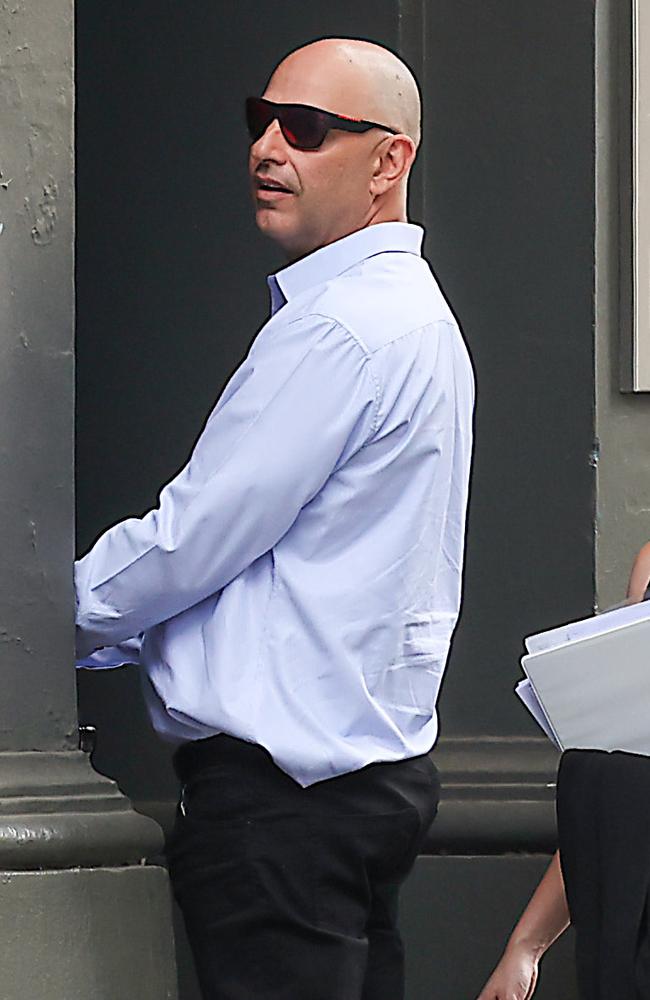 Mr Chadwick tried to hide from media as he left the Melbourne Magistrates’ Court on Monday. Picture: Ian Currie