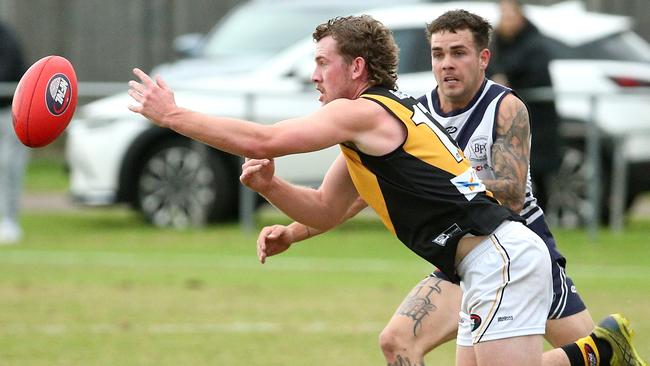 NFL: Heidelberg’s Dylan Clarke has eyes for the ball. Picture: Hamish Blair