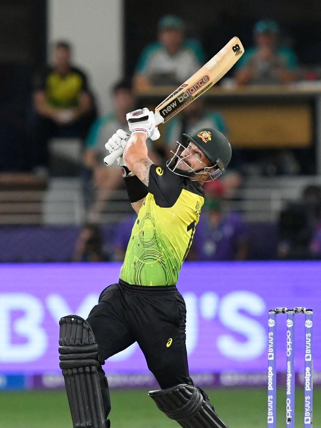 Australia's Matthew Wade hits a six during the ICC men’s Twenty20 World Cup semi-final match between Australia and Pakistan at the Dubai International Cricket Stadium in Dubai on November 11, 2021. (Photo by Aamir QURESHI / AFP)