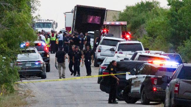 Police at the scene where dozens of people were found dead inside a truck trailer in San Antonio, Texas. Picture: Reuters