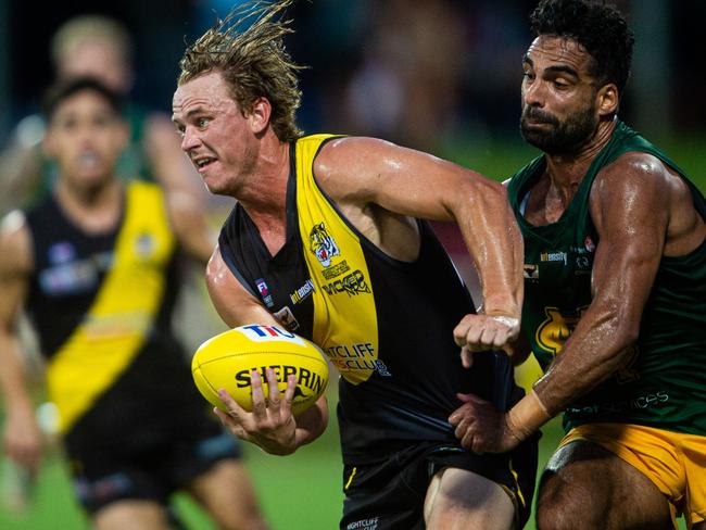 2020-21 NTFL Men's Premier League Grand Final - Nightcliff Tigers v St Mary's. Kyle Emery handballs under pressure.Photograph: Che Chorley