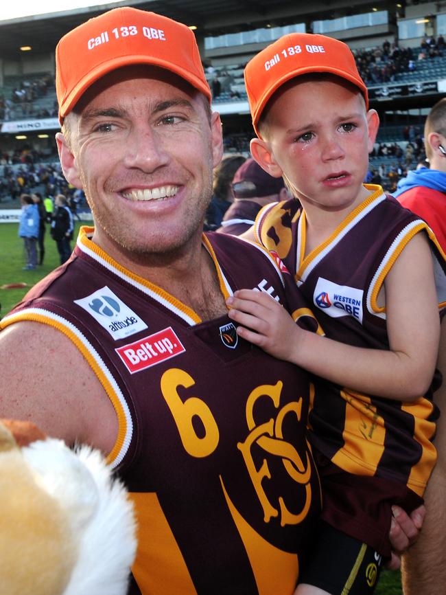 Jarrad Schofield and son Taj after the 2008 WAFL grand final.