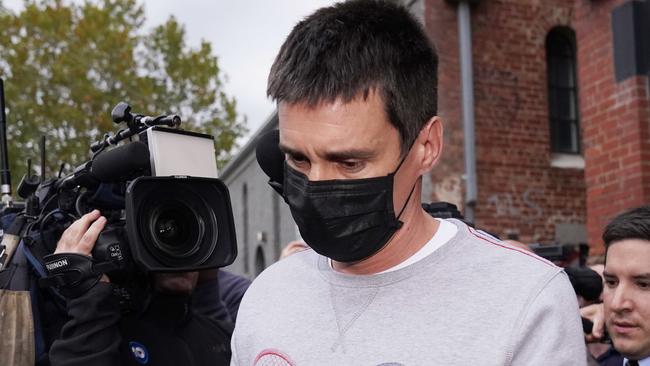 Richard Pusey, the driver of a Porsche who allegedly fled the scene of a truck crash on Melbourne's Eastern Freeway which killed four police officers, is taken away from his Fitzroy property by police in Melbourne, Thursday, April 23, 2020. (AAP Image/Michael Dodge) NO ARCHIVING