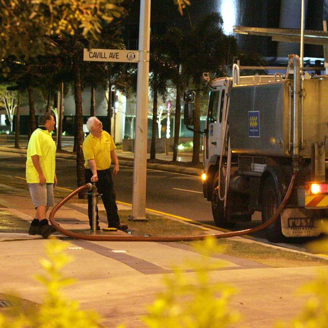 Gold Coast City Council water tankers working in Surfers Paradise. Council workers refilling a water tanker at a fire hydrant at the river end of Cavill Avenue.