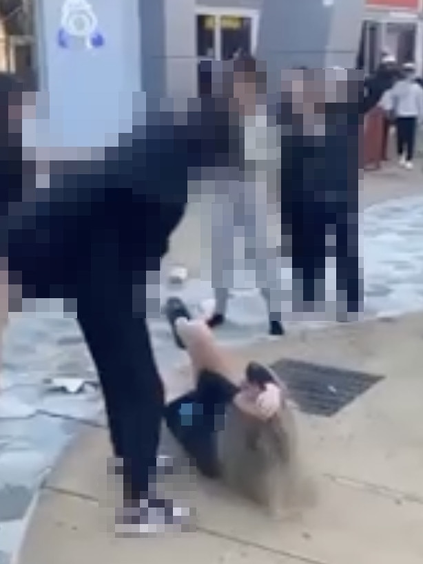 A screenshot from the video of the assault shows the victim laying on the ground outside the food court entrance to the northern suburbs shopping centre. Picture: Supplied