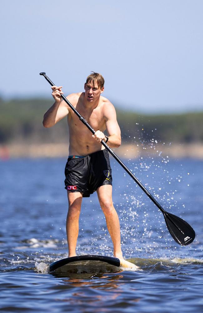 Tom Lynch on a paddleboard at Richmond's pre-season camp in Inverloch on Wednesday.