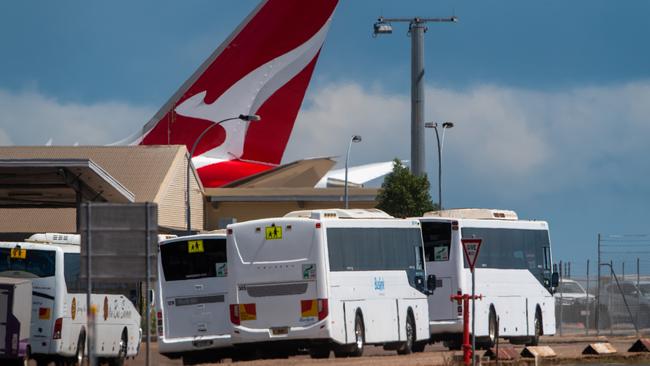 Buses lined up near QF112 parked at Darwin airport ready to take the 183 passengers to the Howard Springs quarantine facility. Picture: Che Chorley