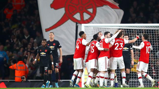 Sokratis Papastathopoulos of Arsenal celebrates with his teammates after scoring his team's second goal against Manchester United Picture: Getty Images