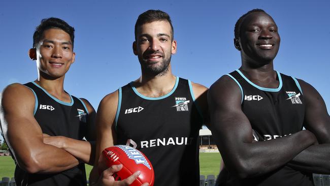 Chen Shaoliang, Jimmy Toumpas and Emmanuel Irra at Alberton Oval. Picture: Sarah Reed