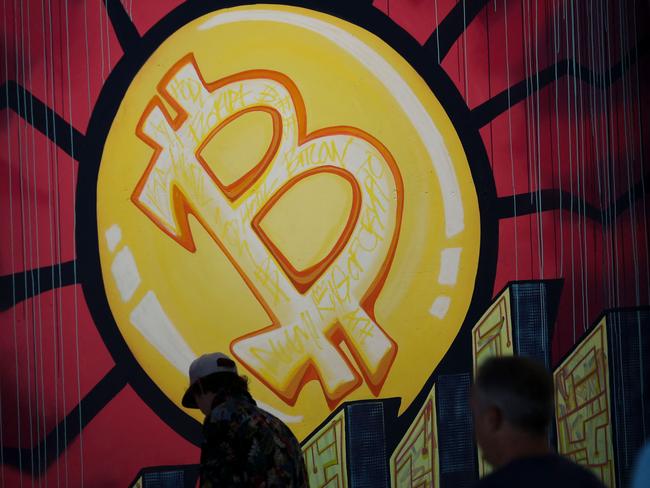 (FILES) In this file photo taken on June 4, 2021 a banner (designed by artists  Stacey Coon, Anastasia Sultzer, and Nanu Berk) with the logo of bitcoin is seen during the crypto-currency conference Bitcoin 2021 Convention at the Mana Convention Center in Miami, Florida. - Investing in bitcoin and other digital currencies remains a risky game where the rules could change significantly, but the payoff could be big. (Photo by Marco BELLO / AFP)