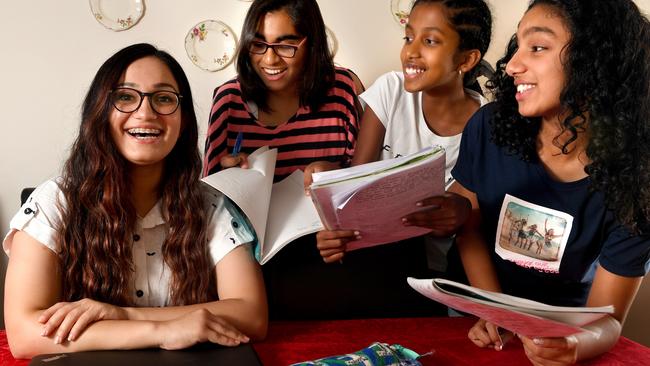 Riya Menon, left, with young students she tutors. Picture: Tricia Watkinson