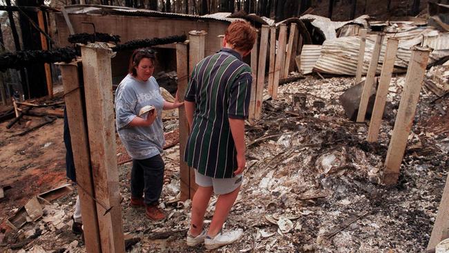 Anna-Marie Shew and her son Darcy, 14, surveying the damage to their Alpine Rd home, which was razed to the ground.