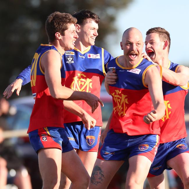 Marong’s Ryan Wellington is swamped by teammates after kicking one of his two goals in the grand final at Mitiamo. Picture: Yuri Kouzmin