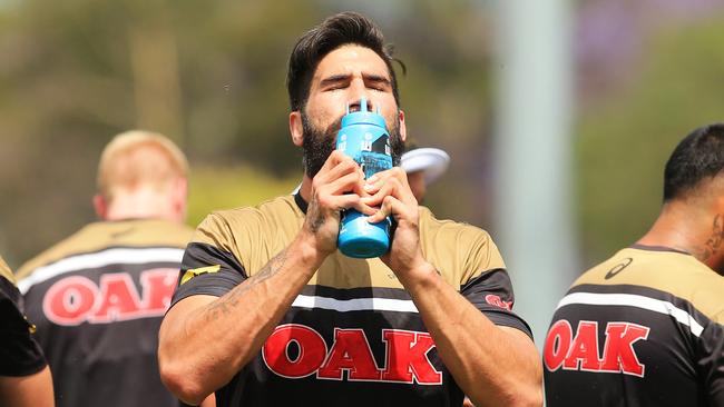James Tamou drinks water with team mates during Penrith Panthers training in 38c heat at the Panthers Academy. pic Mark Evans