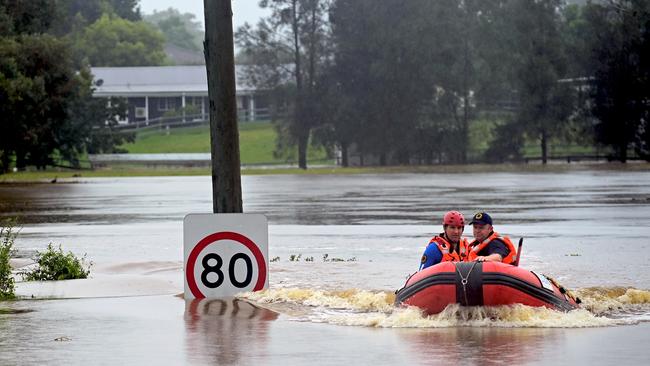 An SES boat patrols the flooded waterways of the Hawkesbury River in Vineyard, NSW. Picture: NCA NewsWire/Jeremy Piper.