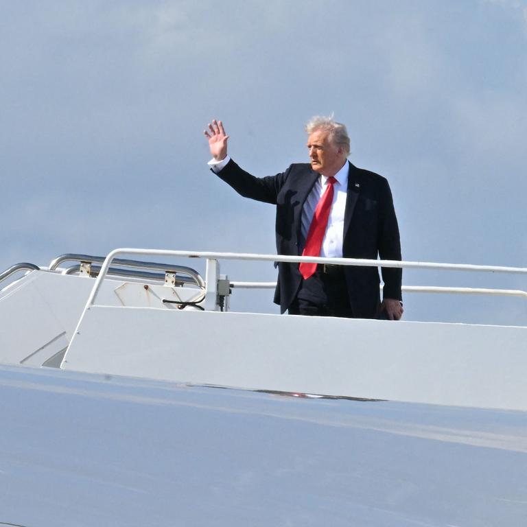 US President Donald Trump waves as he boards Air Force One on his way to New Orleans, Louisiana, to attend Super Bowl LIX. (Photo by ROBERTO SCHMIDT / AFP)