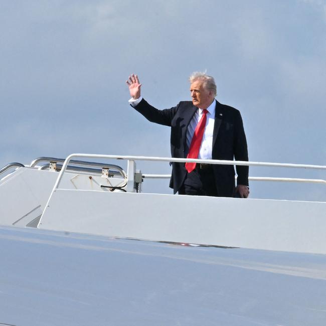 US President Donald Trump waves as he boards Air Force One on his way to New Orleans, Louisiana, to attend Super Bowl LIX. (Photo by ROBERTO SCHMIDT / AFP)