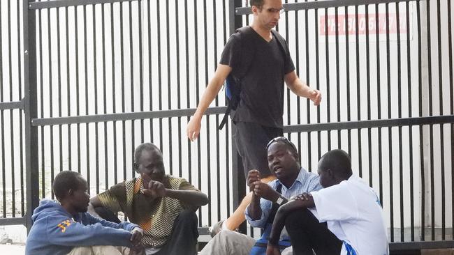 A group of men disregard the new laws on isolation in inner Brisbane. Picture: Lyndon Mechielsen