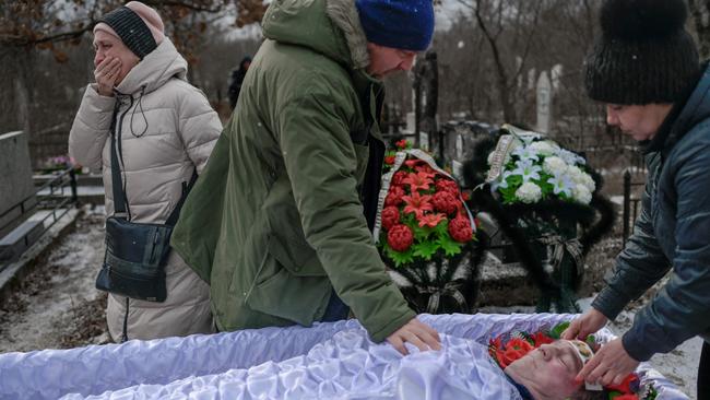 Mourners at the weekend pay their last respects at the funeral of a man killed in shelling in Mykolaiv. Picture: AFP