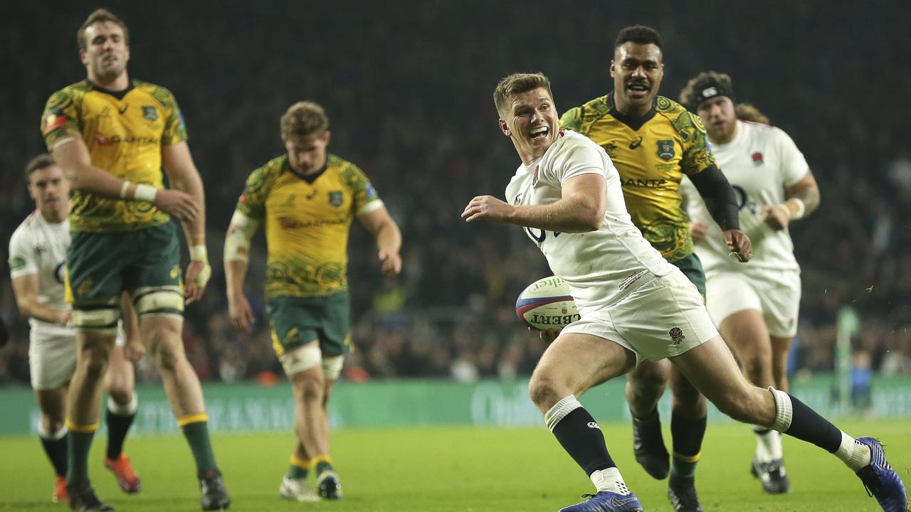 England’s Owen Farrell smiles as he crosses for a try at Twickenham in London.
