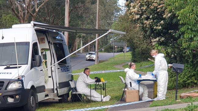 Investigators examining items from the Narara home. Picture: Fiona Killman.