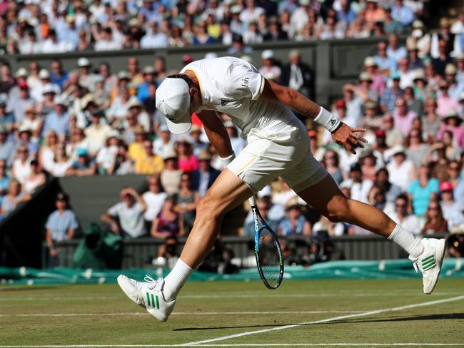 Czech Republic's Tomas Berdych misses a return against Switzerland's Roger Federer.