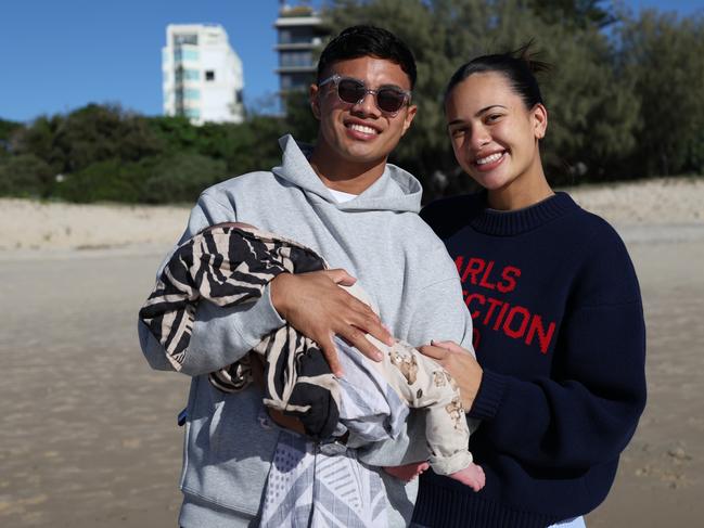 Keano Kini with his young child and partner. Picture: Titans Media.