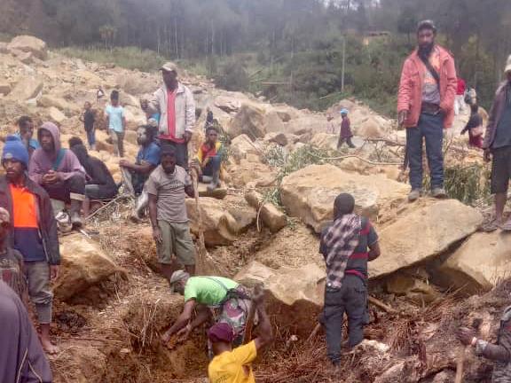 Locals digging at the site of a landslide at Mulitaka village. Picture: AFP/Courtesy of Steven Kandai