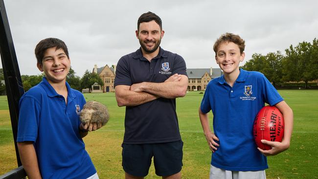 St Peter’s College students, Oscar Kleinig, 13 and Hugh Harper, 13 with the head of personal development Matt French (centre). Picture: Matt Loxton