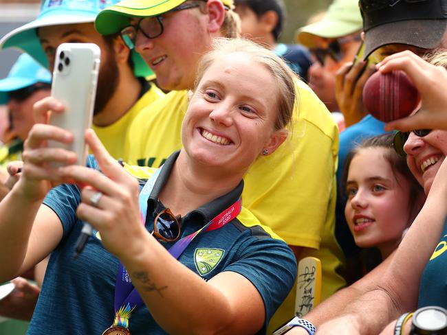 Alyssa Healy takes a selfie with fans at Melbourne’s Federation Square on Monday. Picture: Getty Images