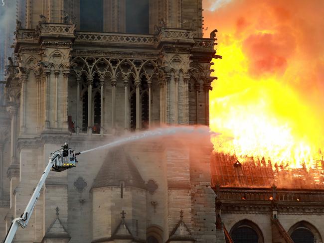 PARIS, FRANCE - APRIL 15: A firefighter is seen fighting the flames at Notre-Dame Cathedral April 15, 2019 in Paris, France. A fire broke out on Monday afternoon and quickly spread across the building, collapsing the spire. The cause is yet unknown but officials said it was possibly linked to ongoing renovation work. (Photo by Pierre Suu/Getty Images)