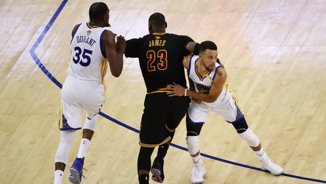 LeBron James battles against Kevin Durant and Stephen Curry in the second half of game two. Picture: AFP