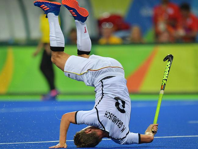 Germany's Mats Grambusch falls during the men's field hockey Canada vs Germany match of the Rio 2016 Olympics Games at the Olympic Hockey Centre in Rio de Janeiro on August, 6 2016. / AFP PHOTO / Carl DE SOUZA