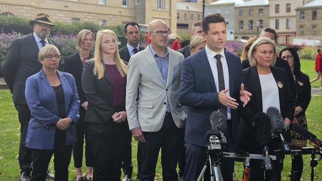 New Labor leader Dean Winter is flanked by caucus as he speaks to the media on Parliament Lawns in Hobart on Wednesday.