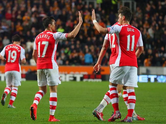 Alexis Sanchez celebrates scoring a goal with Mesut Oezil.