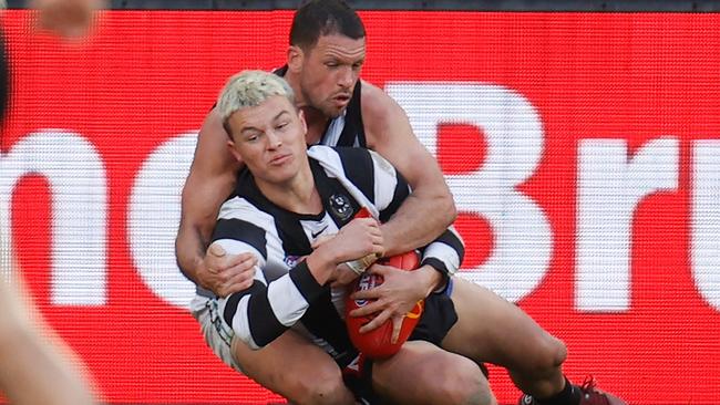 Jack Ginnivan is tackled by Travis Boak in a decision that could have gone either way. Picture: Michael Willson/AFL Photos via Getty Images