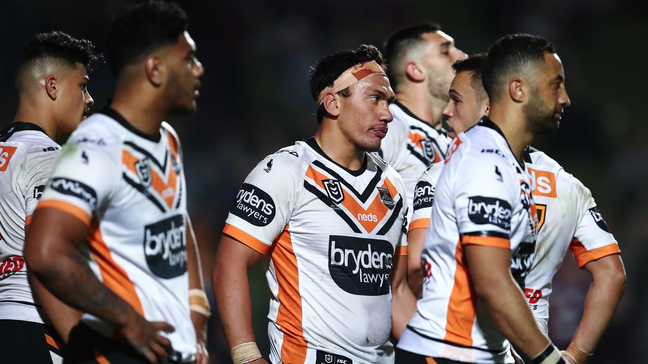 Tigers players look on during the Round 22 NRL match with Manly