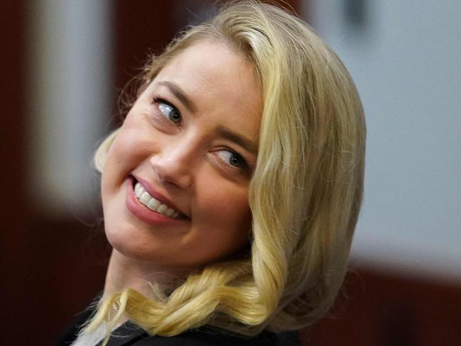 Actor Amber Heard smiles after returning from a break during ex-husband Johnny Depp's defamation trial against her at the Fairfax County Circuit Courthouse in Fairfax, Virginia. (Photo by KEVIN LAMARQUE / POOL / AFP)