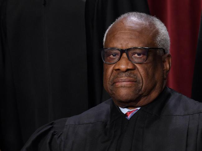 (FILES) In this file photo taken on October 7, 2022 associate US Supreme Court Justice Clarence Thomas poses for the official photo at the Supreme Court in Washington, DC. - A billionaire Republican donor paid for the private school tuition of Justice Clarence Thomas's grandnephew, whom he was raising at the time, a report said on May 4, 2023 -- the latest in a string of ethics controversies surrounding the US Supreme Court. Thomas did not disclose the payments, according to ProPublica, which also reported last month that conservative real estate tycoon Harlan Crow had gifted the longest-serving justice luxury trips over two decades. (Photo by OLIVIER DOULIERY / AFP)