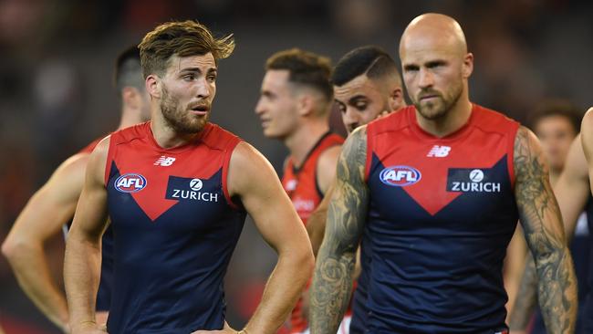 Jack Viney and Nathan Jones lead the Demons off the ground after Friday night’s loss to Essendon. Picture: AAP