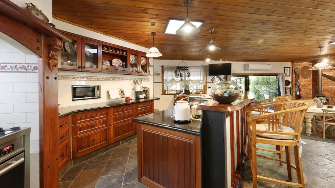 The kitchen is fitted with materials including red gum, jarrah timber and steel.