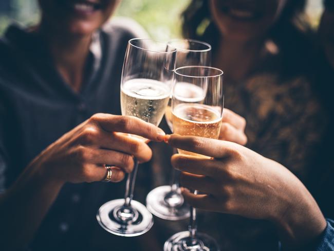 Three female friends celebrating with champagne. They are sitting in a bar and toasting with glasses of champagne.  Picture: istock